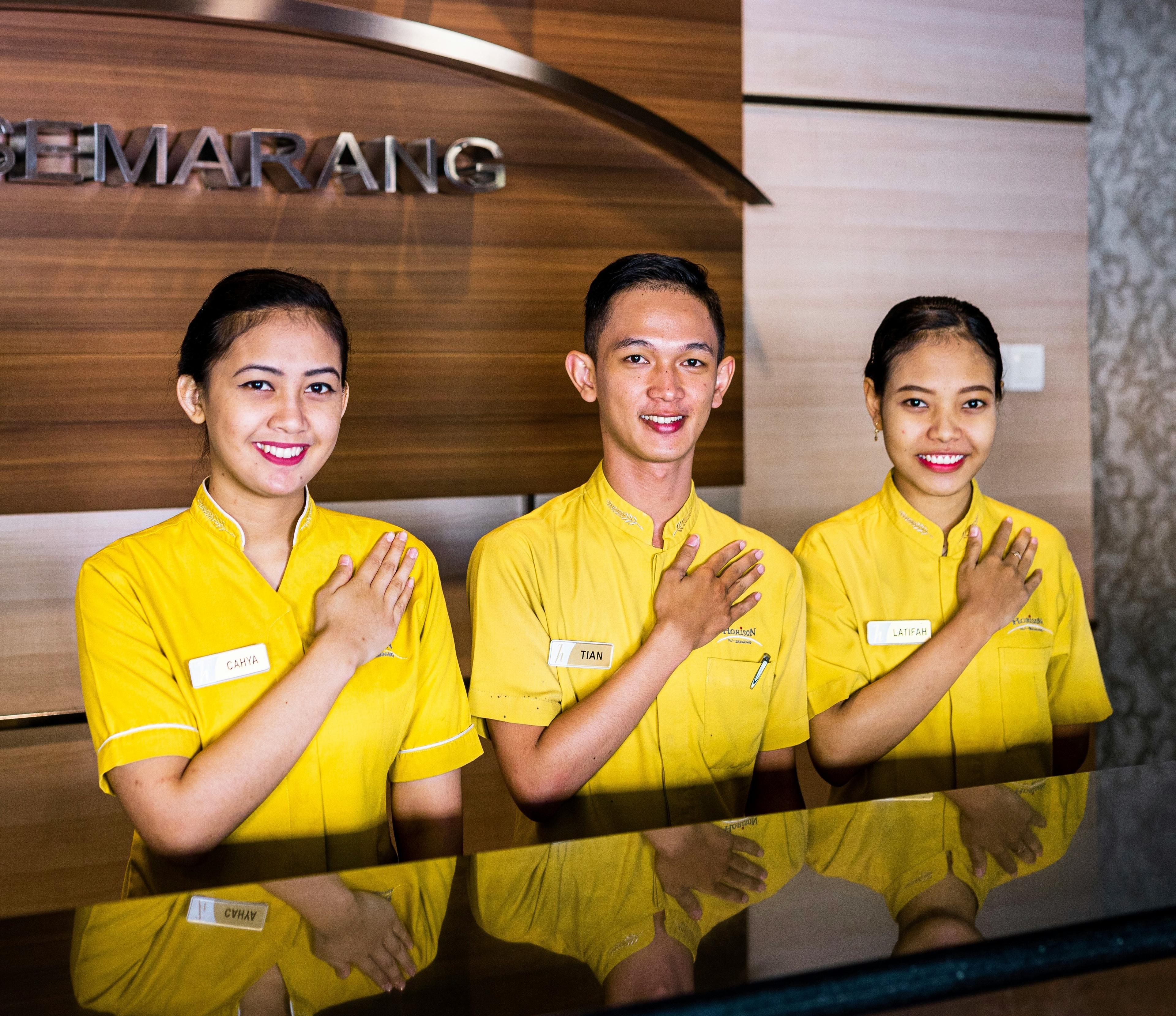 A group of hotel staff at reception.